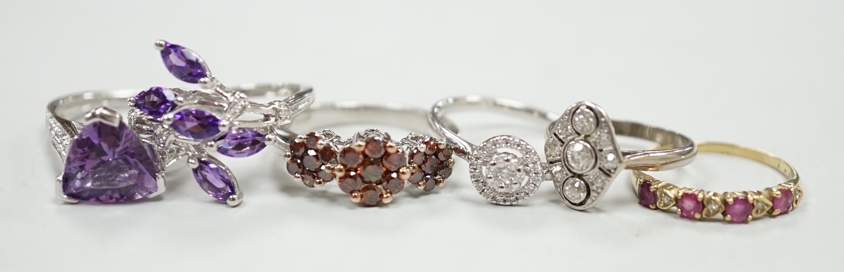 Five assorted modern 9ct gold and gem set dress rings, including diamond cluster ring, gross weight 14.2 grams, together with a 1920's style small white metal and millegrain set diamond cluster ring, size F/G, gross 2.6